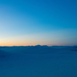 Scenic view of sea against clear sky during sunset