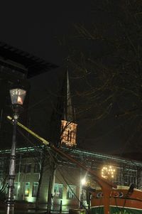 Low angle view of illuminated building against sky at night