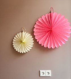 Directly above shot of pink flowers on table against wall