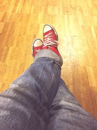 Low section of man standing on hardwood floor