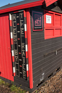 Red telephone booth on wall