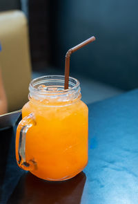 Close-up of orange juice on table