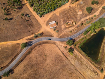 High angle view of road amidst trees on land