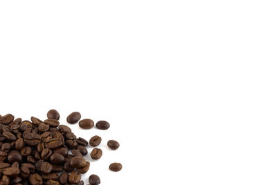 High angle view of coffee beans against white background