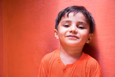 Portrait of smiling boy against wall