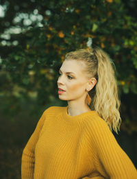 Portrait of beautiful young woman standing outdoors