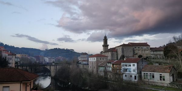 Buildings in town against sky