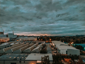 High angle view of illuminated city buildings against sky