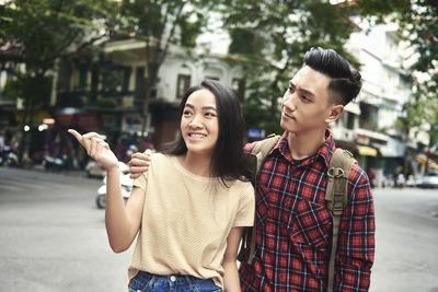 Young women standing on street in city