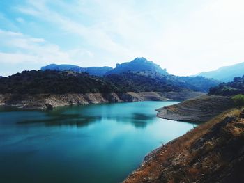 Scenic view of lake and mountains against sky