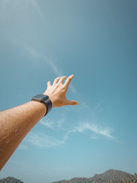 Cropped image of hand against clear sky