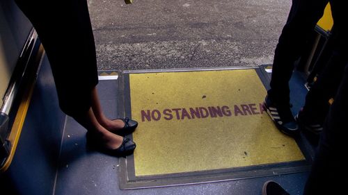 Low section of man with text on bus