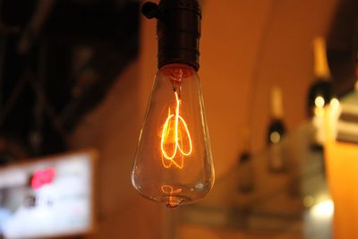 Close-up of illuminated light bulb in bar