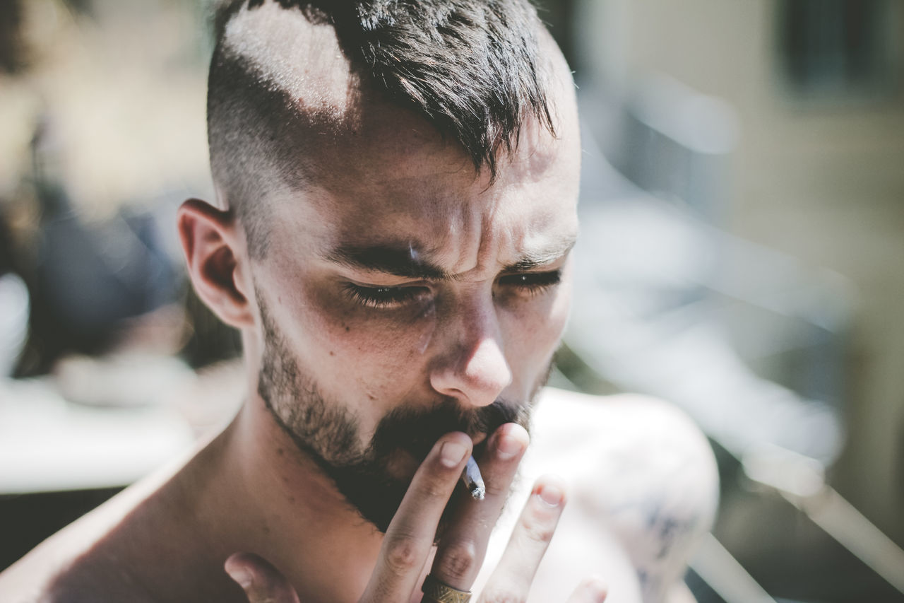 Close-up of man smoking cigarette