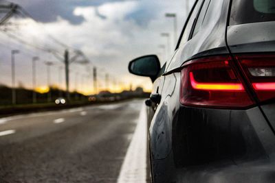 Close-up of car on road against sky