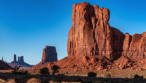 Rock formations on mountain against blue sky