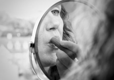 Close-up of woman applying lipstick