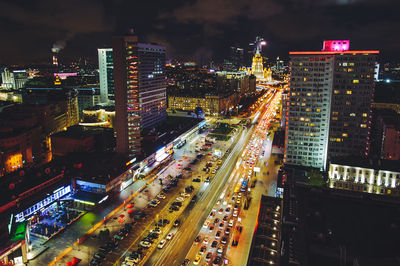 High angle view of illuminated road amidst buildings in city