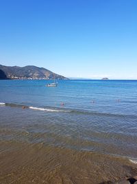 Scenic view of sea against clear blue sky