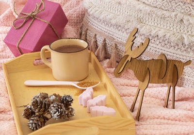 Midsection of woman holding coffee cup on table