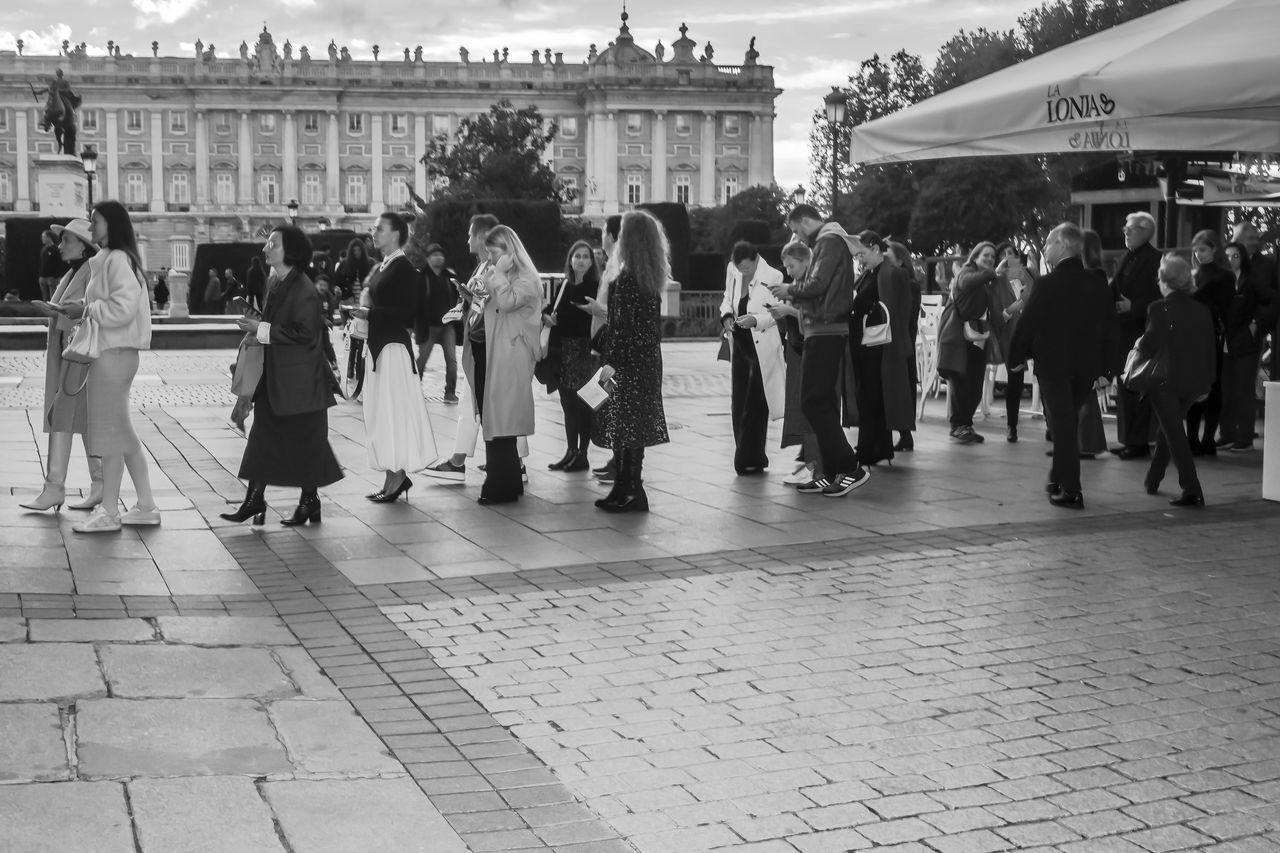 crowd, group of people, architecture, large group of people, city, black and white, building exterior, street, built structure, men, monochrome, women, monochrome photography, road, adult, white, lifestyles, person, sky, dancing, city life, travel destinations, outdoors, arts culture and entertainment, travel, the past, history