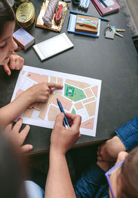 High angle view of people playing on table
