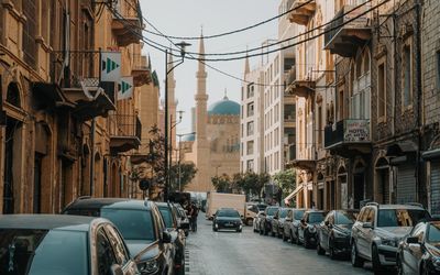 Cars parked on street amidst buildings in city