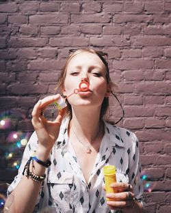 Young woman blowing bubbles