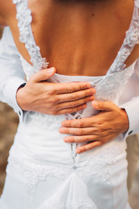 Midsection of woman standing on footpath