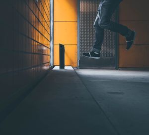 Low section of woman standing on railing