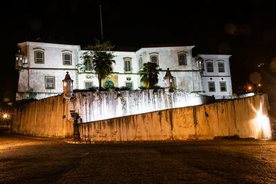 Street amidst buildings in city at night