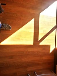 Shadow of woman on hardwood floor