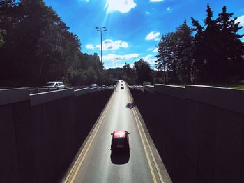 Vehicles on highway against sky