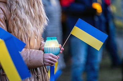 Ukrainian flags, candles and torches in the hands of protesters at the rally stand with ukraine