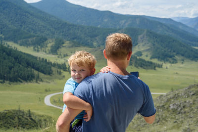 Full length of father and daughter on mountains