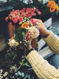 Close-up of hand holding flower bouquet