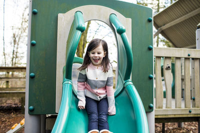Young girl enjoying slide at the playground.