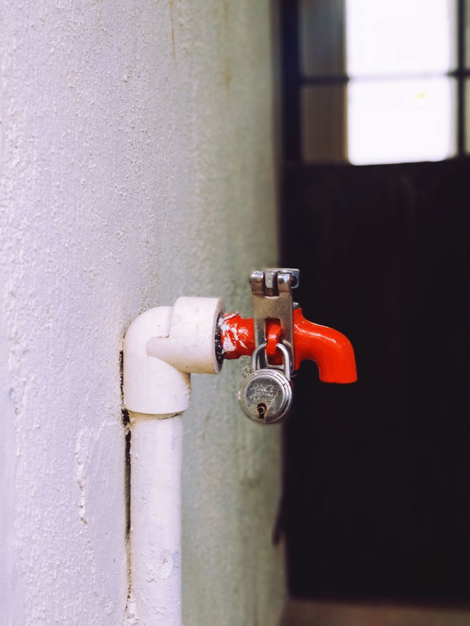 CLOSE-UP OF PIPE AGAINST WALL