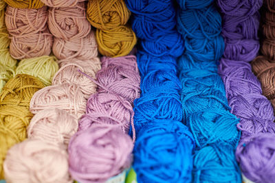 Yarns or balls of wool on shelves in store for knitting and needlework. accessories for haberdashery