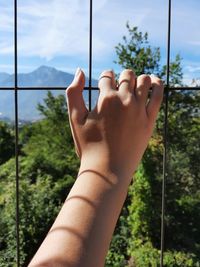 Hand holding on fence