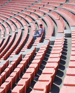 High angle view of man sitting on bleacher at stadium