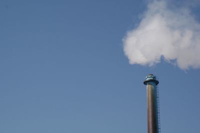 Low angle view of smoke stack against sky