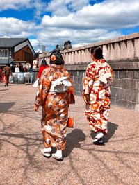 Rear view of women in kimono walking