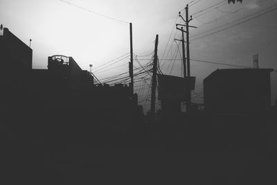 Low angle view of power lines against sky