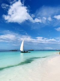 Sailboat in sea against sky