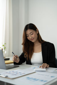Portrait of young businesswoman working at office