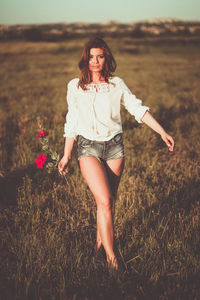 Portrait of beautiful woman on field