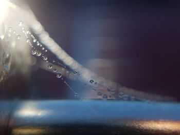 Close-up of water drop against sky