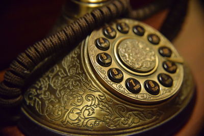 Close-up of old telephone on table