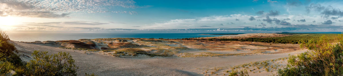 Panoramic view of beach against cloudy sky